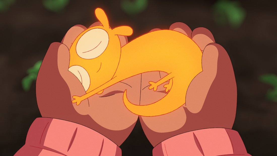 A dragon like magical yellow creature laying happily in the hands of a human.
