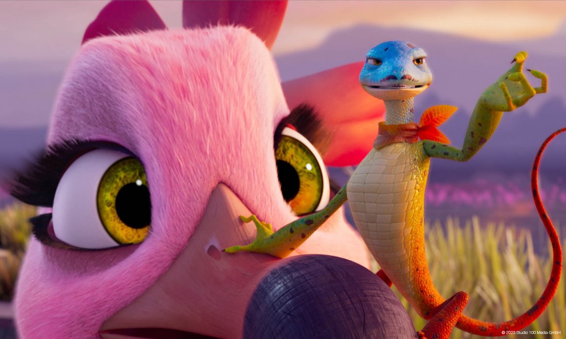 A colourful salamander gesturing theatrically while sitting on the nose of a pink flamingo.